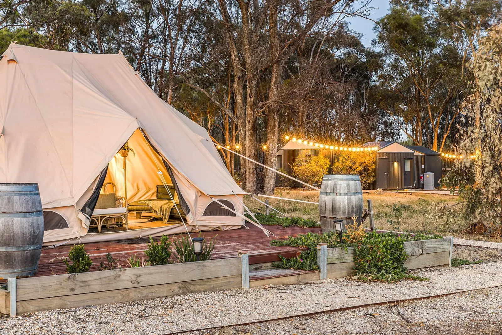 A bell tent lit from inside at dusk