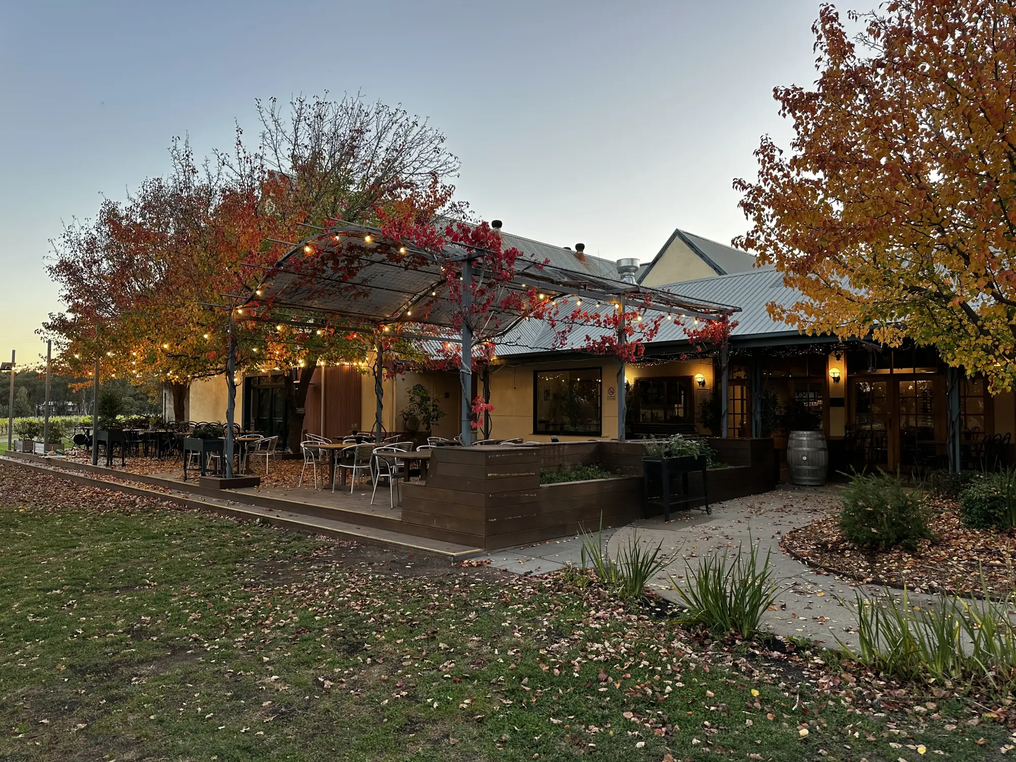 The restaurant at dusk, festoon lights on over the deck