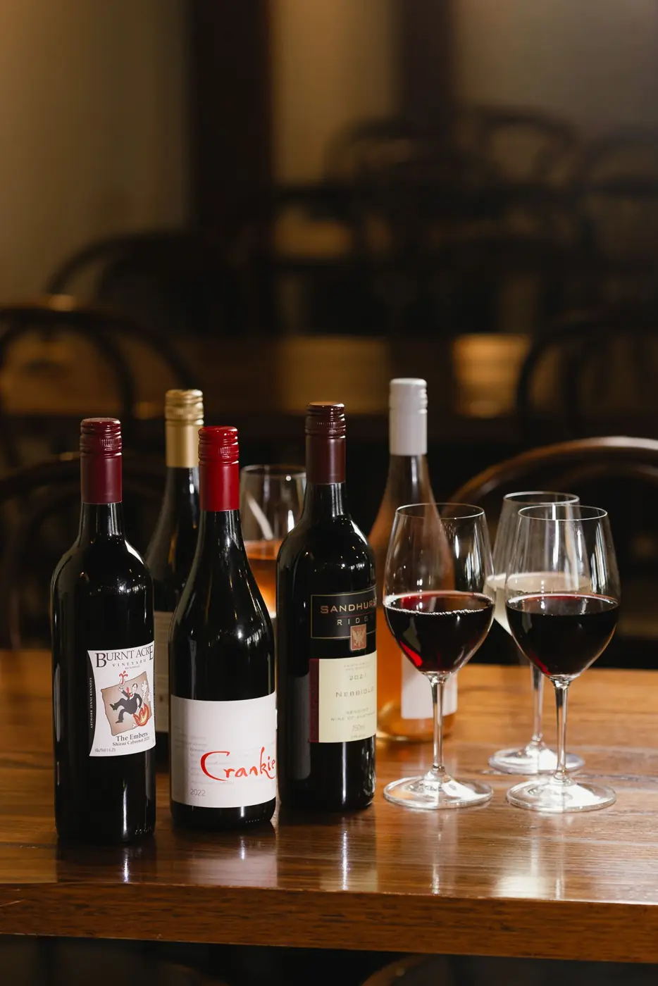 Bottles of red wine and glasses on a table